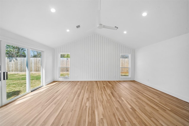 unfurnished living room featuring baseboards, ceiling fan, vaulted ceiling, light wood-style floors, and recessed lighting