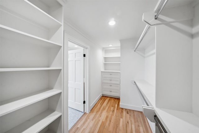 walk in closet featuring light wood-style flooring