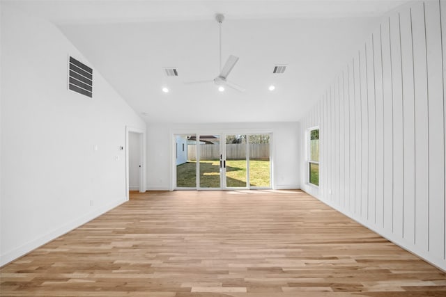 empty room featuring high vaulted ceiling, visible vents, ceiling fan, and light wood finished floors