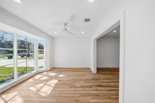 unfurnished room featuring light wood-style floors, visible vents, crown molding, and recessed lighting