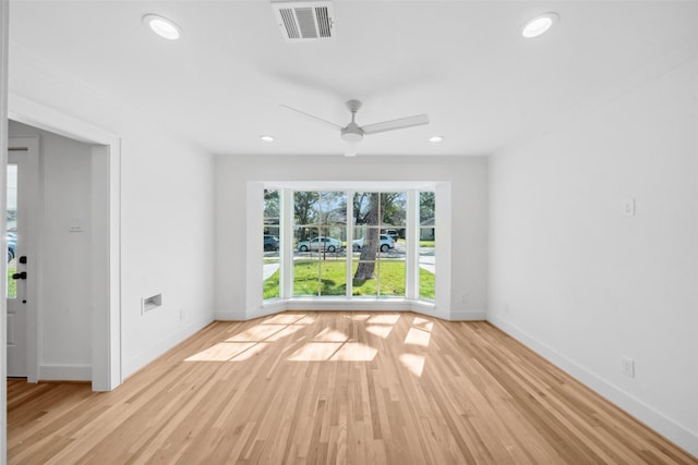 unfurnished room with recessed lighting, visible vents, a ceiling fan, wood finished floors, and baseboards