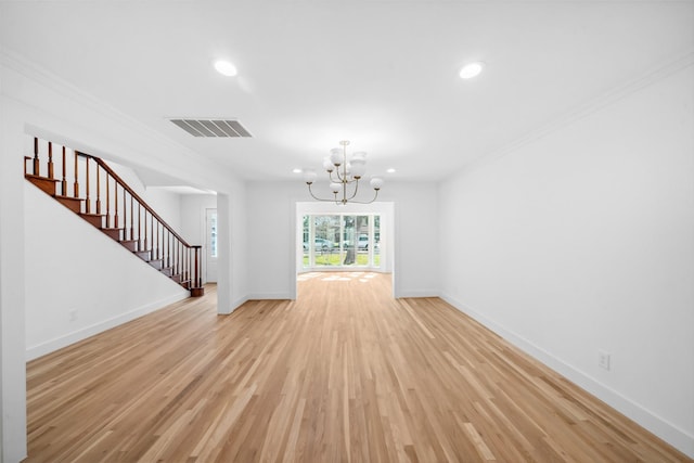 unfurnished living room featuring visible vents, baseboards, ornamental molding, stairway, and light wood-type flooring