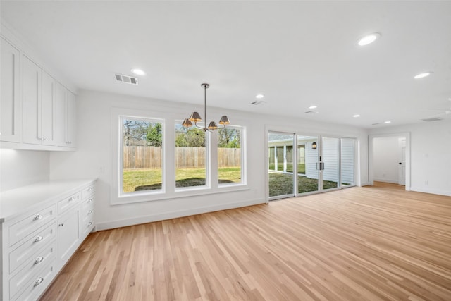 unfurnished living room featuring light wood-style floors, visible vents, and recessed lighting