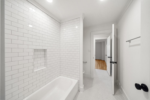 bathroom featuring tile patterned flooring, toilet, and baseboards