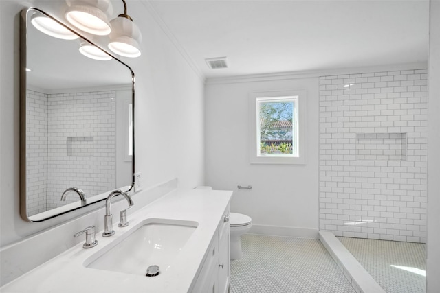 full bath with visible vents, toilet, a tile shower, crown molding, and vanity