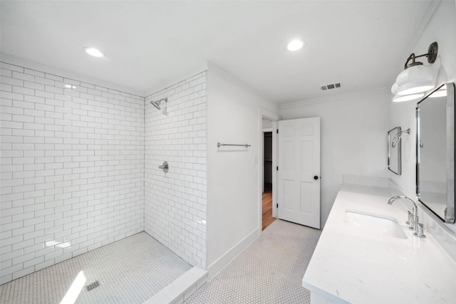 bathroom featuring recessed lighting, visible vents, tiled shower, and vanity