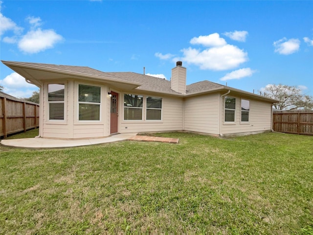 rear view of house featuring a patio and a yard