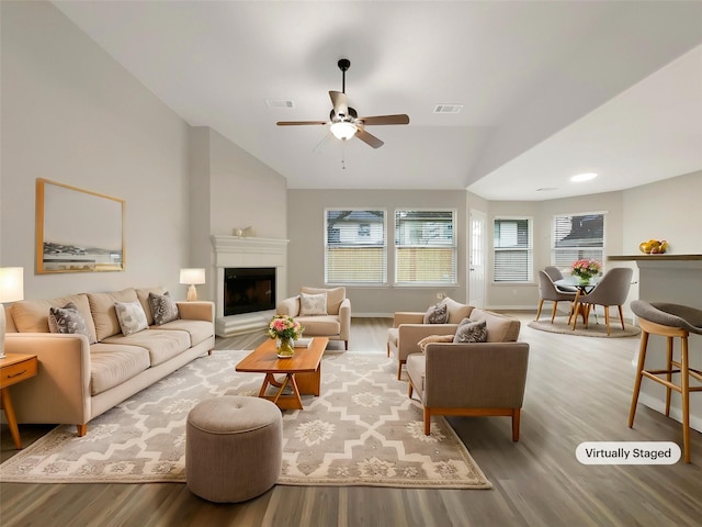 living room with vaulted ceiling, ceiling fan, and hardwood / wood-style flooring