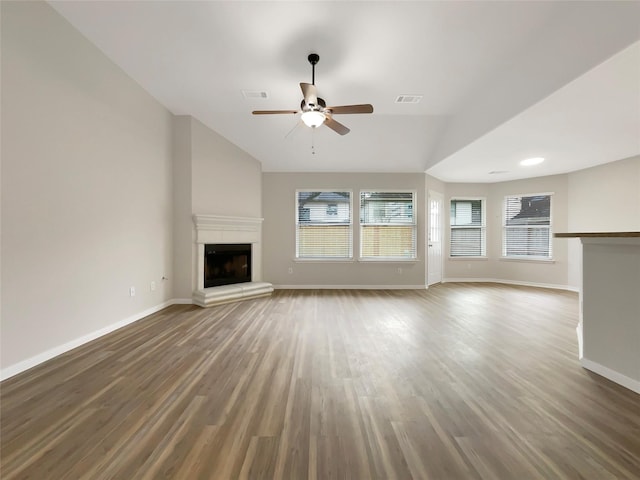 unfurnished living room with hardwood / wood-style floors, lofted ceiling, and ceiling fan