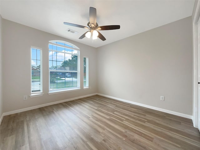 spare room with ceiling fan and wood-type flooring