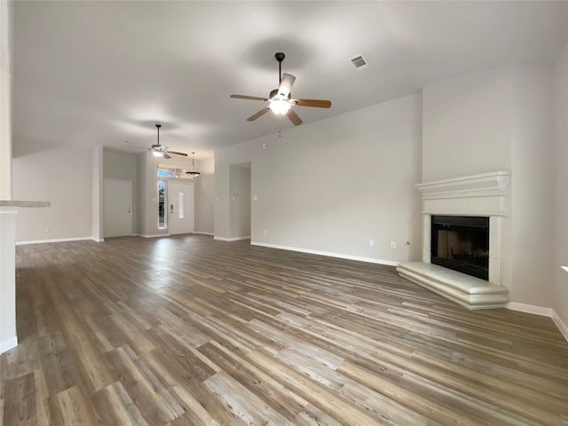 unfurnished living room featuring hardwood / wood-style flooring and ceiling fan