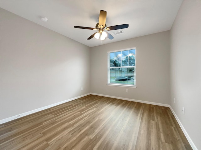 spare room featuring hardwood / wood-style floors and ceiling fan