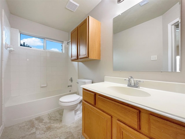 full bathroom with toilet, vanity, and tiled shower / bath