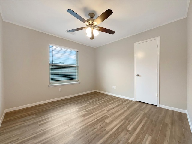 spare room with ornamental molding, ceiling fan, and light hardwood / wood-style flooring