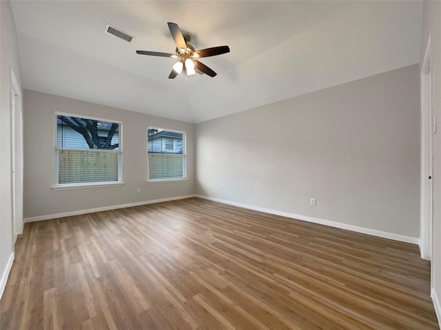 unfurnished bedroom featuring lofted ceiling, ceiling fan, and hardwood / wood-style floors