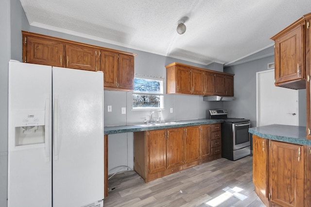 kitchen featuring dark countertops, white refrigerator with ice dispenser, brown cabinetry, and stainless steel range with electric cooktop