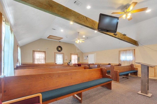 interior space with vaulted ceiling with beams, carpet flooring, visible vents, and a ceiling fan