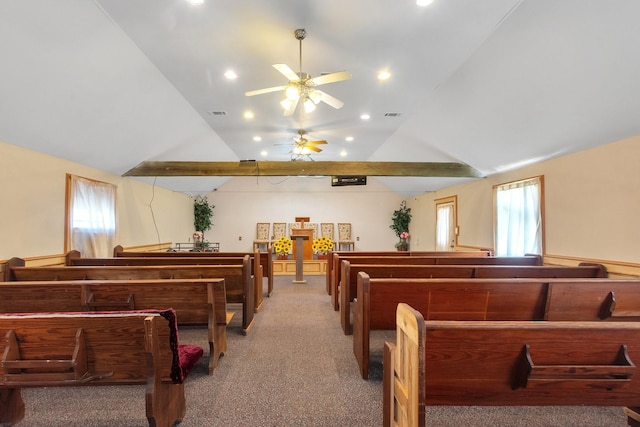 recreation room featuring light carpet, visible vents, a wealth of natural light, and lofted ceiling