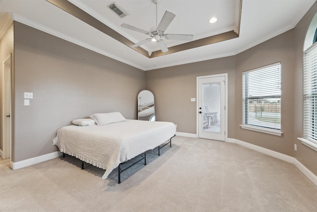 carpeted bedroom featuring a raised ceiling, ceiling fan, crown molding, and access to outside