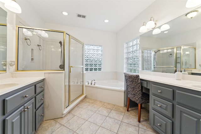 bathroom featuring vanity and shower with separate bathtub