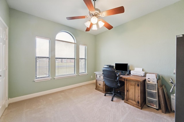 carpeted home office featuring ceiling fan