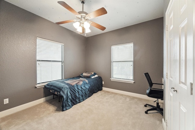 bedroom featuring ceiling fan and light colored carpet