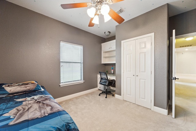 carpeted bedroom with ceiling fan and a closet