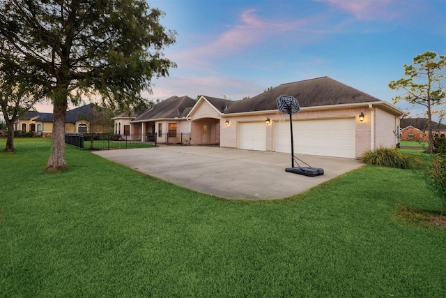 single story home featuring a garage and a yard