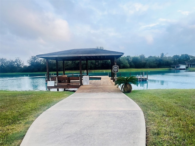 view of dock with a yard, a water view, and a gazebo