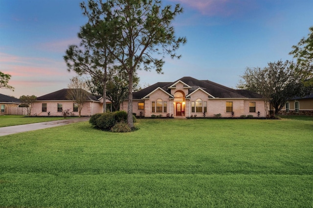 ranch-style home with a lawn