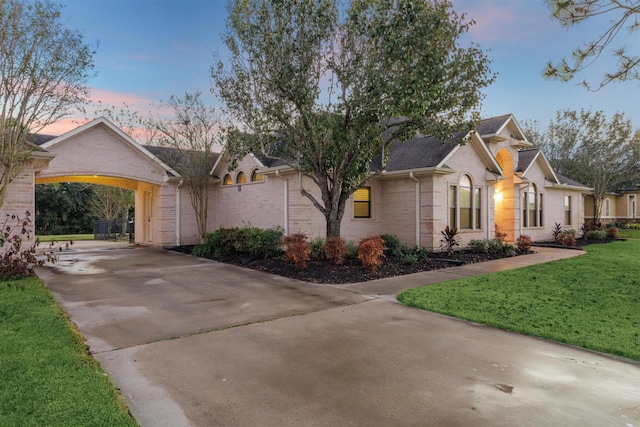 ranch-style house featuring a yard and a carport