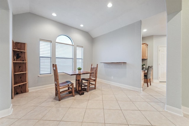 tiled dining area with vaulted ceiling