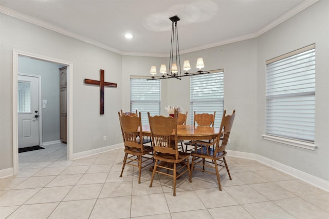 tiled dining room with an inviting chandelier and ornamental molding