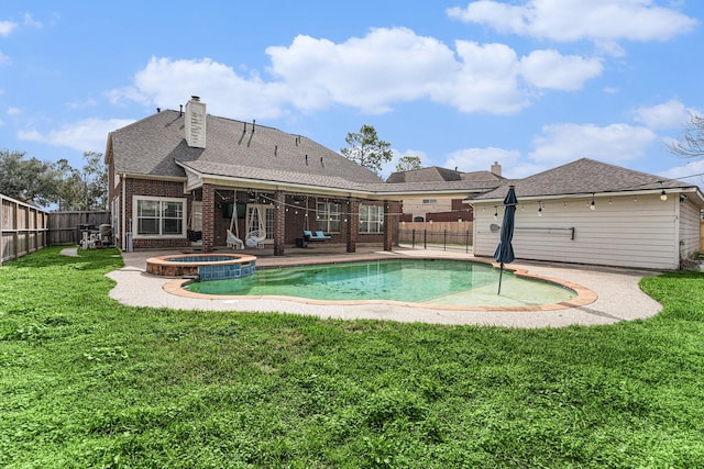 view of swimming pool with a yard, a patio area, a fenced backyard, and a pool with connected hot tub