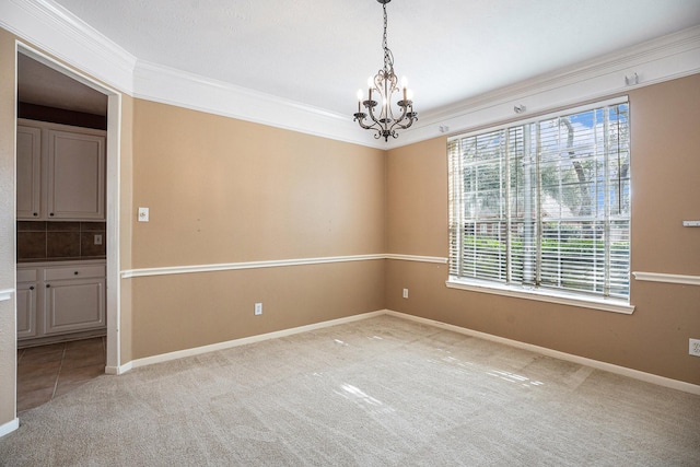 unfurnished room featuring light carpet, baseboards, a chandelier, and crown molding