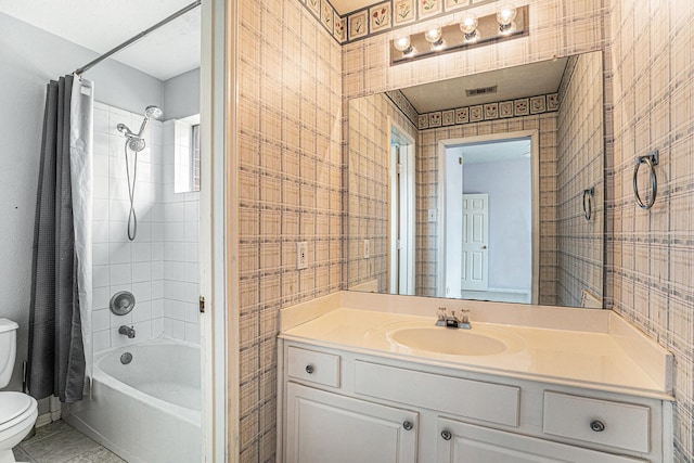 bathroom with visible vents, toilet, shower / bath combo, vanity, and tile patterned flooring