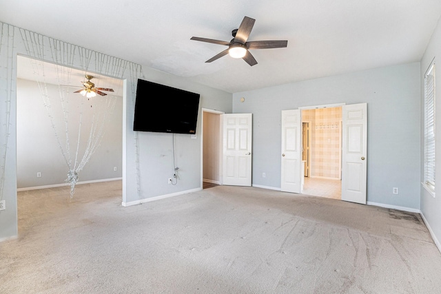 unfurnished bedroom with carpet, baseboards, and a ceiling fan