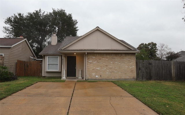 ranch-style house with a front yard and a patio area