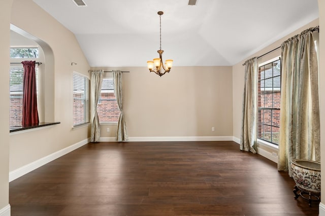 spare room with dark hardwood / wood-style floors, a wealth of natural light, and lofted ceiling