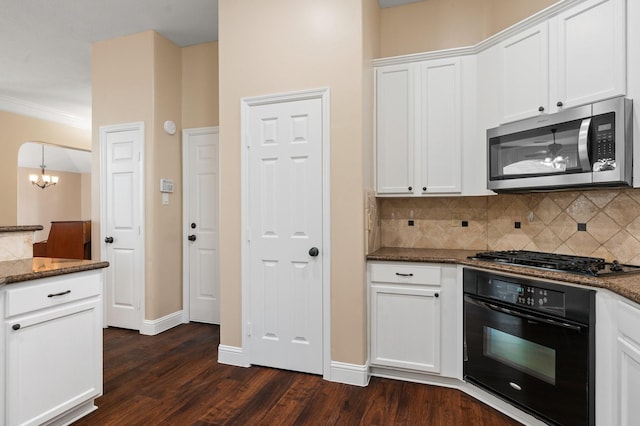 kitchen featuring oven, white cabinetry, dark stone counters, and gas cooktop