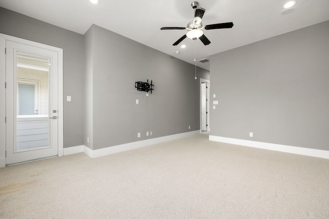 carpeted empty room featuring ceiling fan