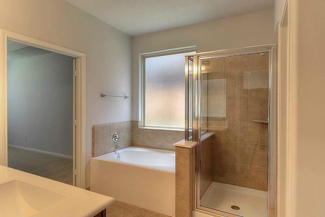 bathroom with separate shower and tub, vanity, and tile patterned flooring