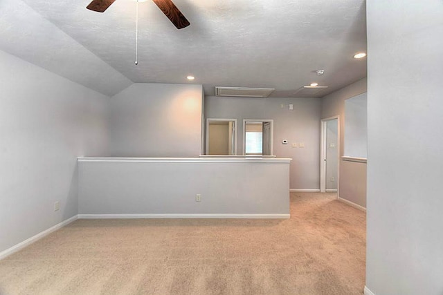 carpeted spare room with lofted ceiling and ceiling fan