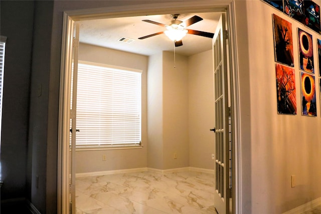 interior space with ceiling fan