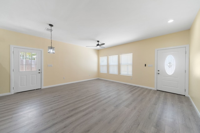 foyer featuring baseboards, ceiling fan, visible vents, and light wood-style floors