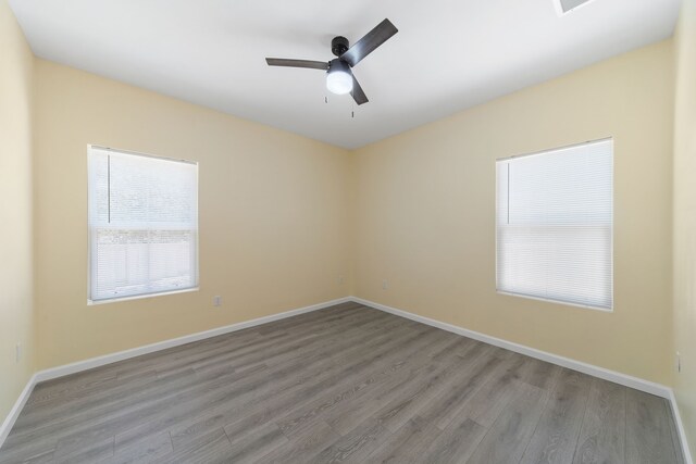 unfurnished room featuring baseboards, ceiling fan, and light wood finished floors