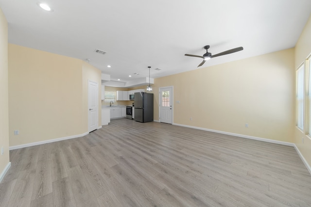 unfurnished living room featuring light wood finished floors, baseboards, visible vents, a ceiling fan, and recessed lighting