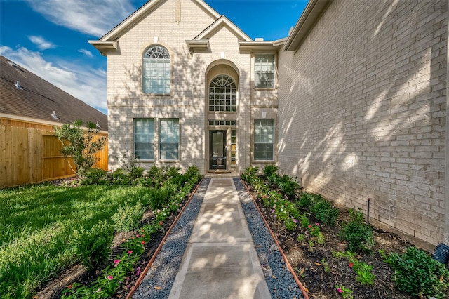 property entrance with a lawn