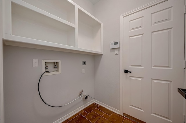 washroom featuring hookup for a washing machine, gas dryer hookup, electric dryer hookup, and dark tile patterned floors