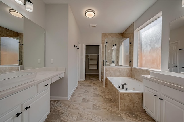 bathroom with independent shower and bath and vanity